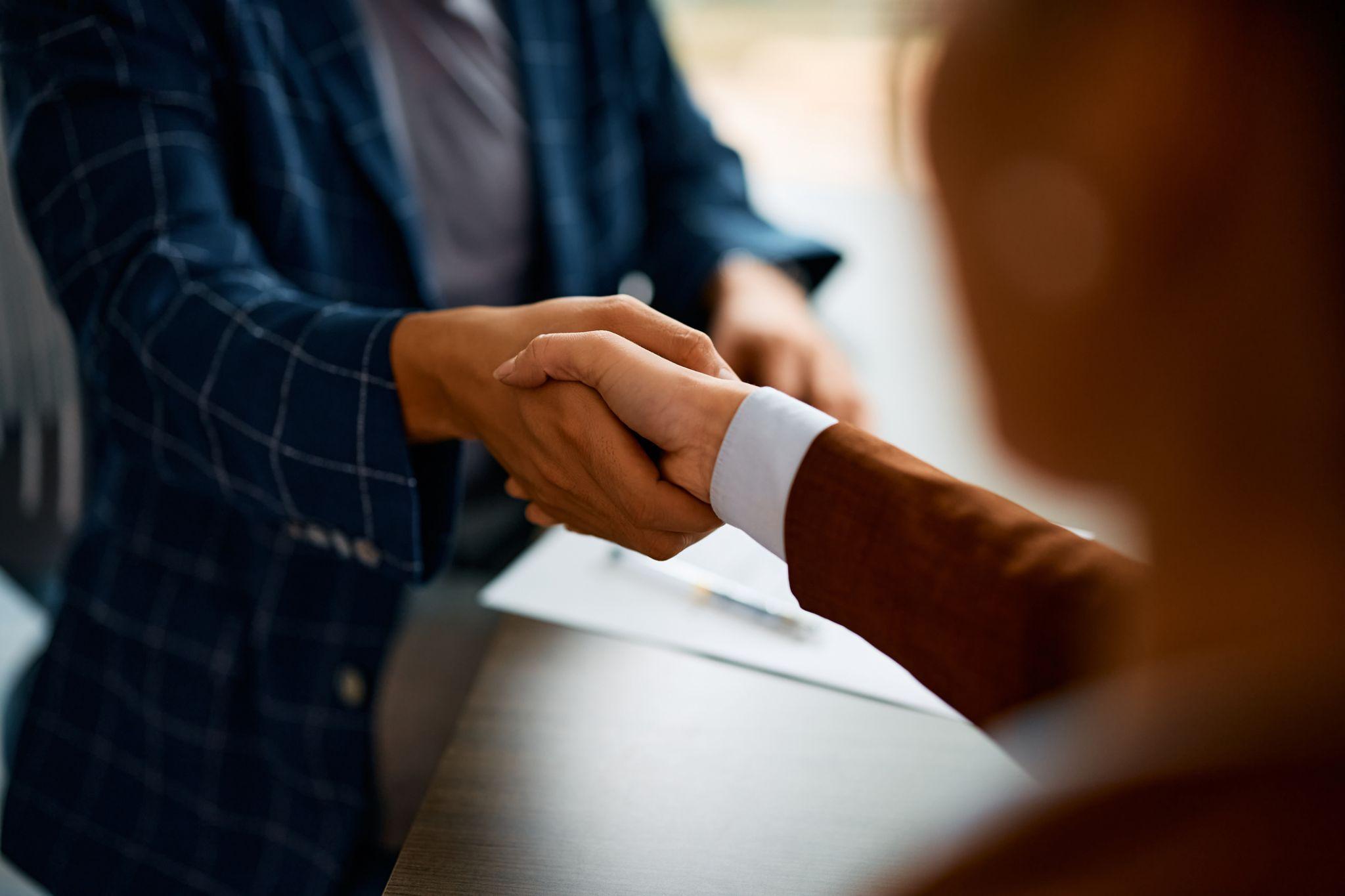 Insurance agent shaking hands with client